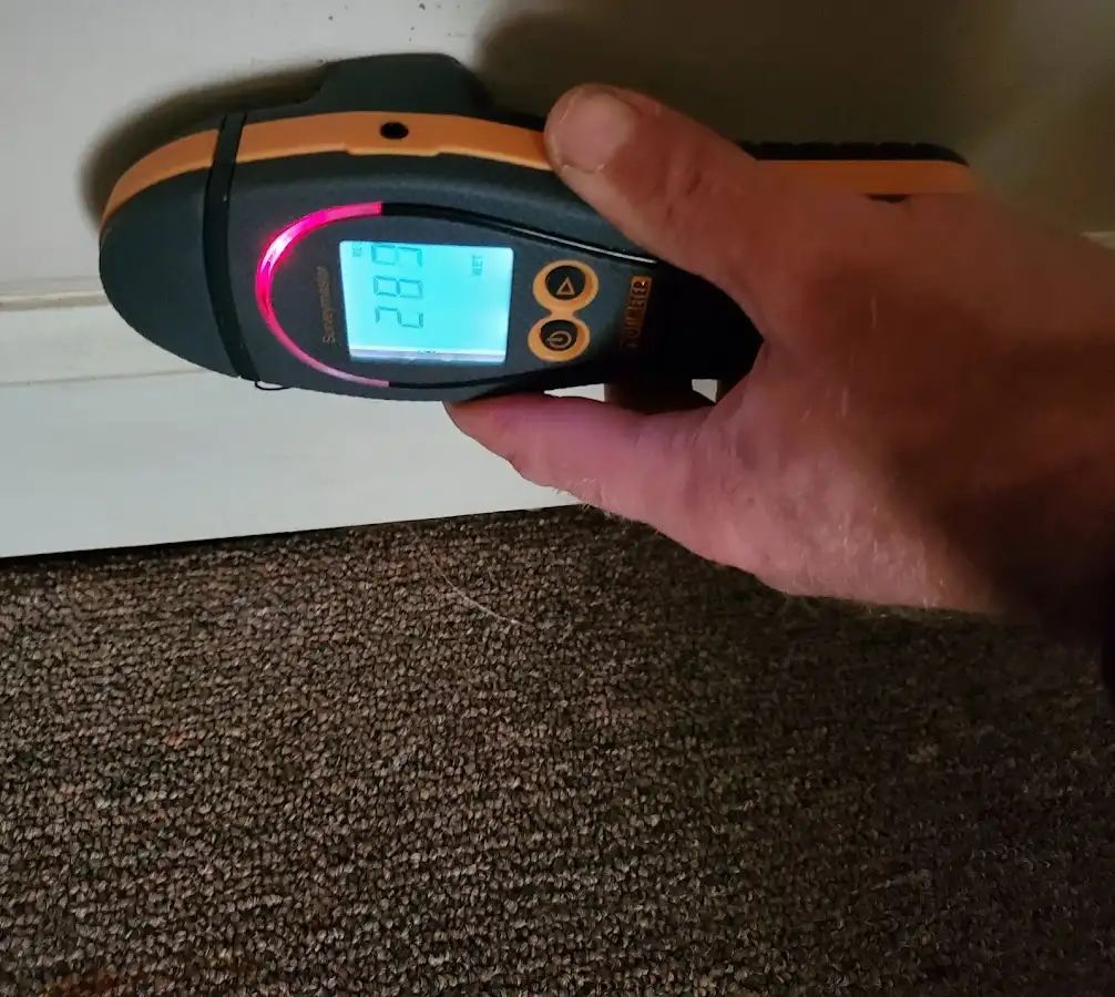 Moisture detection at baseboard during Storm Damage Restoration in Helena
